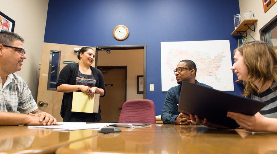 Training around table in conference room