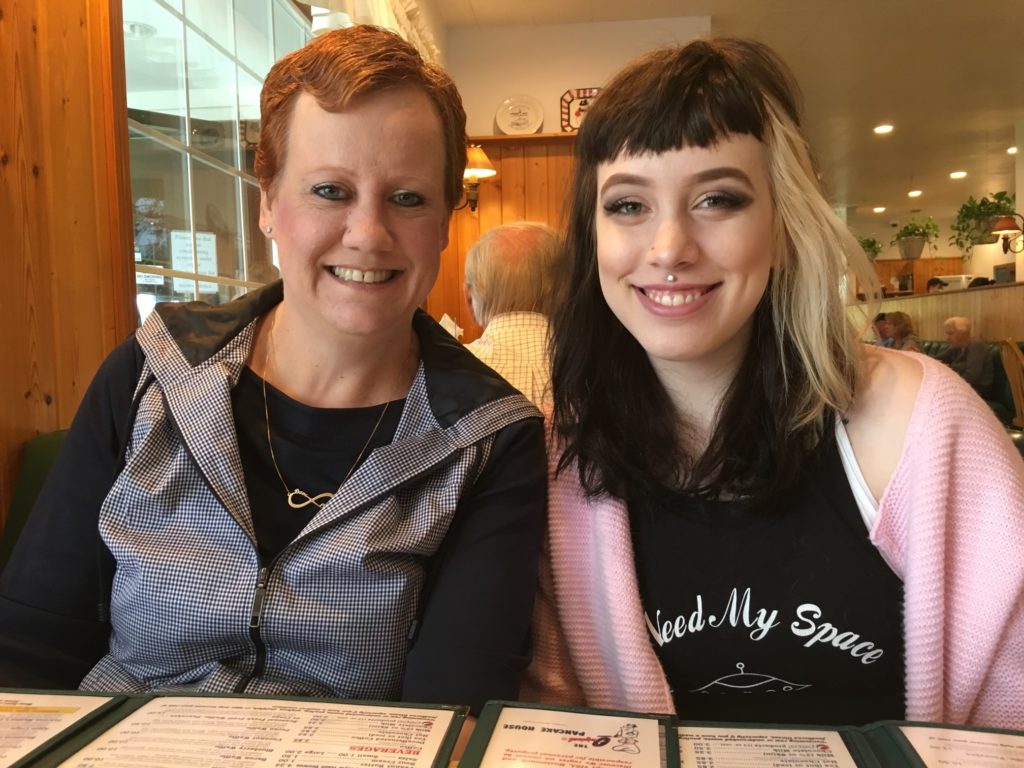 Mother and daughter smiling in restaurant